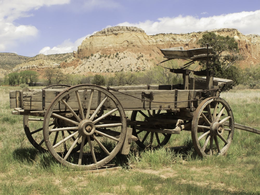 Basic transportation in the Old West wooden wagon on grassy valley floor in New Mexico